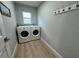 Functional laundry room featuring a modern washer and dryer at 1137 Treasure Cay Ct, Punta Gorda, FL 33950