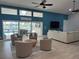 Cozy living room featuring stylish seating, vaulted ceilings, and serene views of the water at 1137 Treasure Cay Ct, Punta Gorda, FL 33950