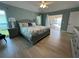 Comfortable main bedroom featuring a king-size bed, ensuite bathroom, and access to a private pool area at 1137 Treasure Cay Ct, Punta Gorda, FL 33950