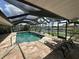 Backyard pool with screened enclosure, waterfront canal view, and outdoor lounge chairs at 1137 Treasure Cay Ct, Punta Gorda, FL 33950