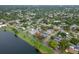 An aerial shot shows the property's proximity to a lake and its location in a serene residential area at 1180 39Th N St, St Petersburg, FL 33713