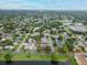 An aerial view shows this home is nestled in a quiet neighborhood with mature trees and a nearby lake at 1180 39Th N St, St Petersburg, FL 33713
