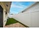 Enclosed backyard with white vinyl fence and artificial grass at 1180 39Th N St, St Petersburg, FL 33713