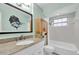 Well-lit bathroom with vanity, and tub with shower and window at 1180 39Th N St, St Petersburg, FL 33713