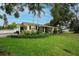 Landscaped front yard with palm trees complements this beautiful single Gathering home at 1180 39Th N St, St Petersburg, FL 33713