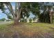 Single-Gathering home with a sprawling front yard, mature trees, and a tranquil neighborhood setting at 1180 39Th N St, St Petersburg, FL 33713