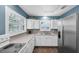 Well-lit kitchen boasts white cabinetry, modern appliances, and a stylish backsplash for a contemporary feel at 1180 39Th N St, St Petersburg, FL 33713