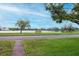 Scenic view of the lake and its surroundings from across the street, with a bench to enjoy the scenery at 1180 39Th N St, St Petersburg, FL 33713