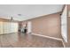 Inviting living room featuring neutral wall color, ceiling fan, tile flooring, wood accent wall and TV at 1180 39Th N St, St Petersburg, FL 33713
