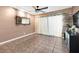 Spacious living room featuring tile flooring, ceiling fan, wood accent wall, and stylish mirror at 1180 39Th N St, St Petersburg, FL 33713