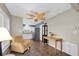Inviting living room with comfortable armchair, warm lighting, and adjacent kitchen entrance at 1180 39Th N St, St Petersburg, FL 33713