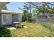 Outdoor patio area with a stone table set in a green lawn, next to a shed at 1183 35Th Ne Ave, St Petersburg, FL 33704