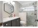 Modern bathroom features elegant vanity with quartz countertop, hexagon mirror, and glass-enclosed walk-in shower with marble tile at 1183 35Th Ne Ave, St Petersburg, FL 33704
