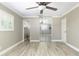 Spacious bedroom with wood-look floors, natural light, ceiling fan, and mirrored closet doors at 1183 35Th Ne Ave, St Petersburg, FL 33704