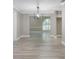 Elegant dining area with light wood-look floors, modern chandelier, and neutral decor at 1183 35Th Ne Ave, St Petersburg, FL 33704