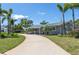 Inviting ranch-style home featuring a curved driveway, mature landscaping, and a neutral-toned facade at 1183 35Th Ne Ave, St Petersburg, FL 33704