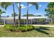 Charming single-story home with a well-manicured lawn, palm trees, and a light gray exterior paint at 1183 35Th Ne Ave, St Petersburg, FL 33704