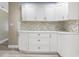 Modern kitchen showcasing white cabinets, elegant hardware, and a stylish backsplash, creating a sophisticated culinary space at 1183 35Th Ne Ave, St Petersburg, FL 33704
