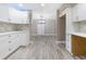 Bright kitchen featuring white cabinets, quartz countertops and herringbone backsplash, seamlessly connected to the adjacent dining area at 1183 35Th Ne Ave, St Petersburg, FL 33704