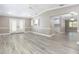 Spacious living room with tile floors and view to kitchen, and natural light from French doors and plantation shutters at 1183 35Th Ne Ave, St Petersburg, FL 33704