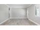 Open-concept living room with light wood-look floors, white trim, and ample natural light at 1183 35Th Ne Ave, St Petersburg, FL 33704