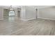 Spacious living room showcasing light wood-look floors, crown molding, and an open layout at 1183 35Th Ne Ave, St Petersburg, FL 33704