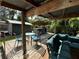 Backyard featuring a wooden deck with seating, an outdoor kitchen and lush landscaping at 1211 E Curtis St, Tampa, FL 33603