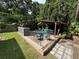 Outdoor deck space perfect for entertaining featuring a cooking area and dining set at 1211 E Curtis St, Tampa, FL 33603