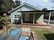 Cozy backyard with a wooden deck, covered porch and outdoor seating area at 1211 E Curtis St, Tampa, FL 33603