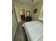 Bedroom with gray vinyl flooring and view into the living room through an open door at 1211 E Curtis St, Tampa, FL 33603