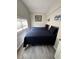 Bedroom with two twin beds featuring vinyl floors and bright natural light at 1211 E Curtis St, Tampa, FL 33603