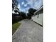 Gravel driveway leading to the backyard shed, offering ample parking at 1211 E Curtis St, Tampa, FL 33603