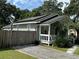 Charming exterior view of the home with a white porch, and stone pathway at 1211 E Curtis St, Tampa, FL 33603