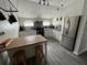 Bright kitchen with stainless steel appliances, island with stools, and modern countertops at 1211 E Curtis St, Tampa, FL 33603