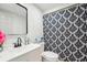 Bathroom with framed mirror, sink and vanity, toilet, and decorative shower curtain at 12701 Cornell Ct, Hudson, FL 34667