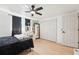 Bedroom features a ceiling fan, light wood floors, closet, and vanity with lighted mirror at 12701 Cornell Ct, Hudson, FL 34667