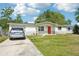 A well-maintained single-Gathering home with a bright red door and manicured front yard at 12701 Cornell Ct, Hudson, FL 34667