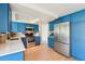 Bright kitchen features blue cabinets, stainless steel appliances and light countertops at 12701 Cornell Ct, Hudson, FL 34667