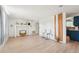 Spacious living room featuring wood floors, minimalist decor, and open layout to the kitchen at 12701 Cornell Ct, Hudson, FL 34667