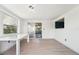 Bright living room features light wood floors, white walls, and sliding glass doors at 12701 Cornell Ct, Hudson, FL 34667