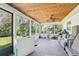 Enclosed patio with multiple windows, fan, and plenty of room for seating and relaxing at 12701 Cornell Ct, Hudson, FL 34667