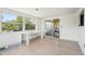 Bright sunroom with large windows and sliding glass doors and light-colored flooring at 12701 Cornell Ct, Hudson, FL 34667