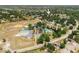 Aerial view of a home near community amenities, including sports fields, pool, and green spaces at 12815 Tallowood Dr, Riverview, FL 33579