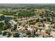 View of a single-story home in a lakeside community with mature trees and manicured lawns at 12815 Tallowood Dr, Riverview, FL 33579