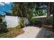 Backyard area features a well-kept grill and is surrounded by lush greenery and a privacy fence at 12815 Tallowood Dr, Riverview, FL 33579