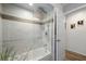 Bathroom featuring a tub, shower, and door at 12815 Tallowood Dr, Riverview, FL 33579