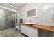 Modern bathroom featuring a frameless glass shower and a floating vanity with a vessel sink at 12815 Tallowood Dr, Riverview, FL 33579