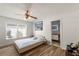 Bright bedroom with wood-look floors, ceiling fan, and an en-suite bathroom at 12815 Tallowood Dr, Riverview, FL 33579