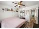 Bedroom with a pink bed, mirrored closet, and wood-look tile flooring at 12815 Tallowood Dr, Riverview, FL 33579