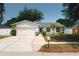 Charming single-story home featuring a stone facade, well-manicured lawn, and a two-car garage at 12815 Tallowood Dr, Riverview, FL 33579